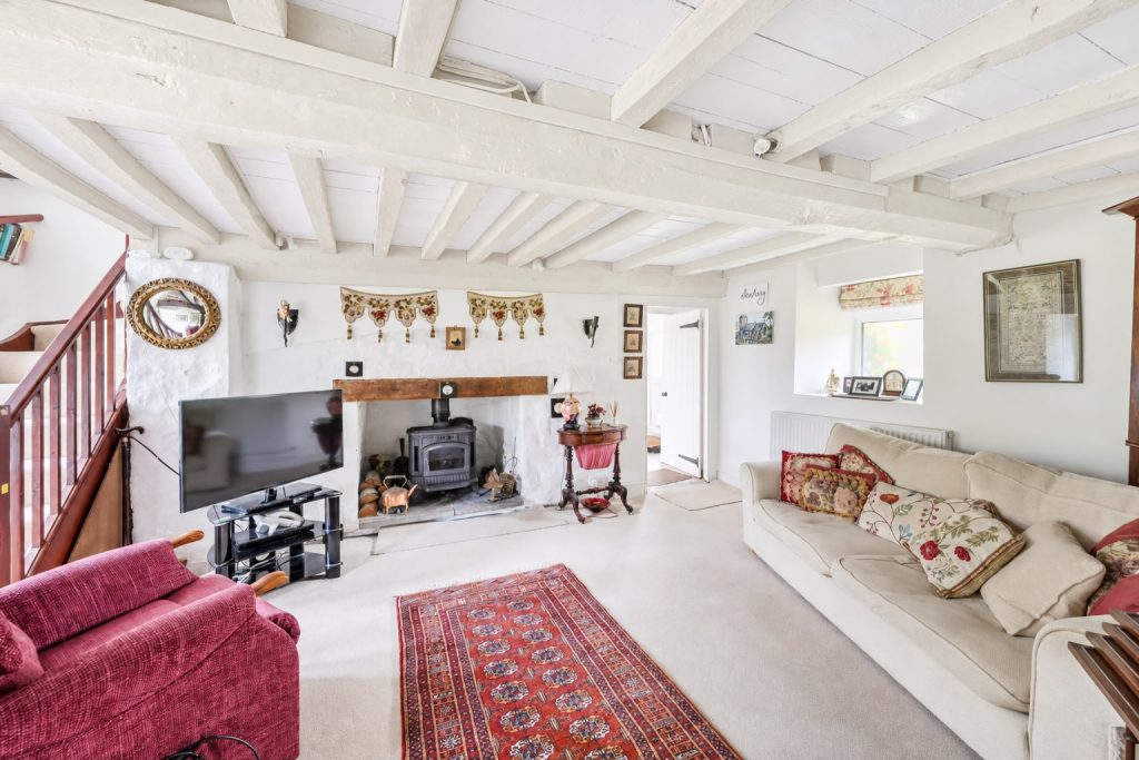 Sitting room at Ivy Cottage, Llanmaes, with beamed ceiling and log burner